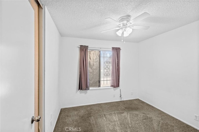 carpeted empty room with baseboards, a textured ceiling, and ceiling fan