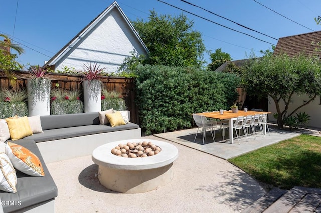 view of patio with a fenced backyard and an outdoor living space with a fire pit