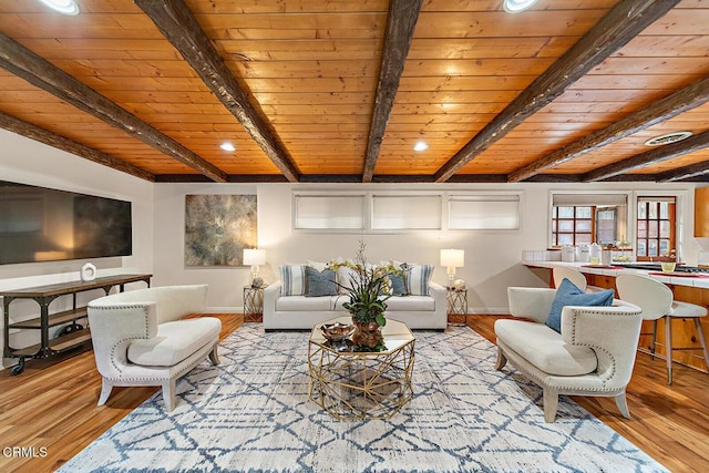 living room with wood ceiling, baseboards, and beam ceiling