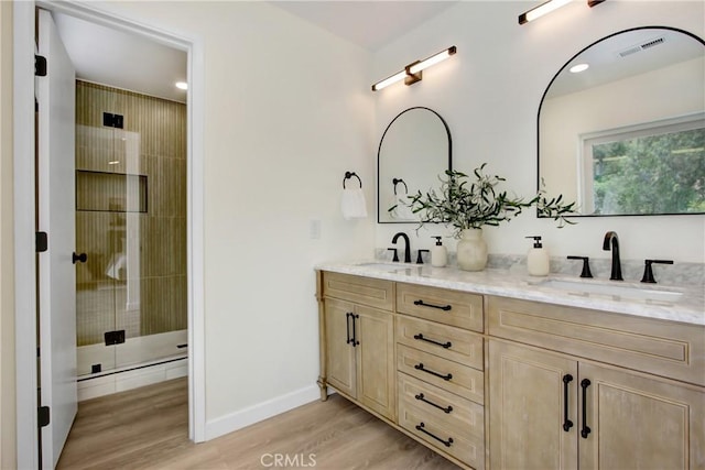 2583 King Way, Claremont, CA 91711 - bathroom with double vanity, wood finished floors, a stall shower, baseboards, and recessed lighting