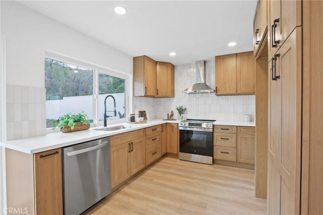 2583 King Way, Claremont, CA 91711 - kitchen with wall chimney exhaust hood, tasteful backsplash, a sink, light wood-style flooring, and appliances with stainless steel finishes