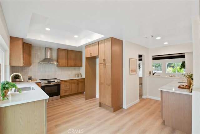 2583 King Way, Claremont, CA 91711 - kitchen featuring electric stove, wall chimney exhaust hood, a sink, light wood-type flooring, and a tray ceiling