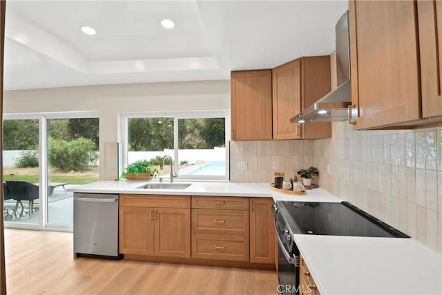 2583 King Way, Claremont, CA 91711 - kitchen featuring stainless steel dishwasher, range with electric stovetop, a sink, wall chimney range hood, and light wood-style flooring