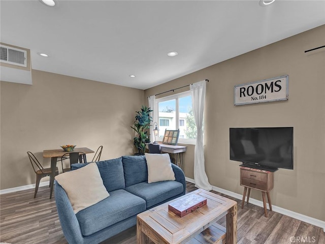 living room with baseboards, recessed lighting, wood finished floors, and visible vents