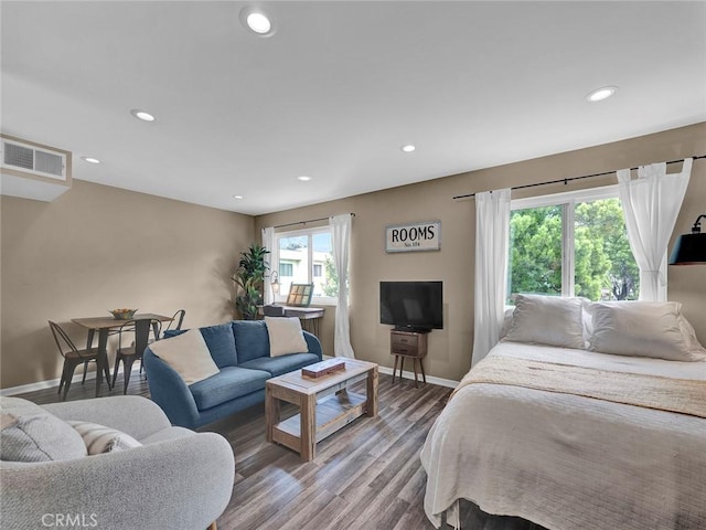 bedroom with recessed lighting, baseboards, visible vents, and wood finished floors