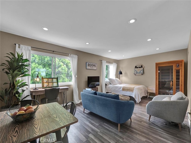 living room with baseboards, recessed lighting, and wood finished floors