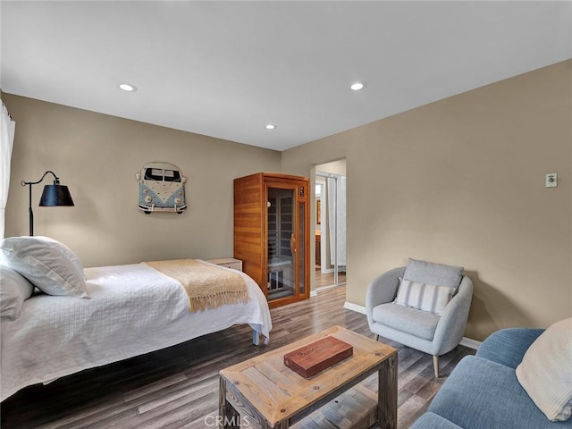 bedroom featuring baseboards, recessed lighting, and wood finished floors