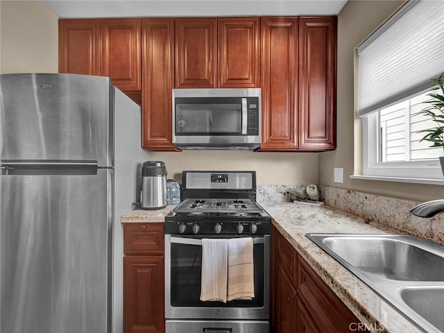 11813 Runnymede St Unit 44, North Hollywood, CA 91605 - kitchen with stainless steel appliances, dark brown cabinets, light stone countertops, and a sink