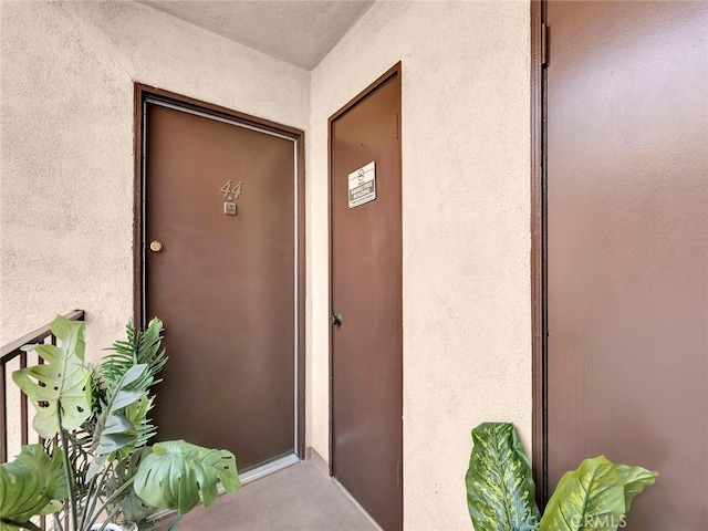 doorway to property with stucco siding