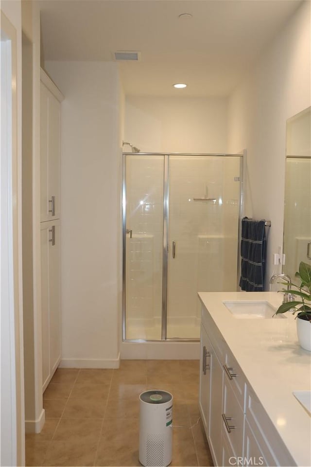 4211 E Malagon Privado Unit 66, Ontario, CA 91761 - full bath with visible vents, double vanity, tile patterned flooring, and a shower stall