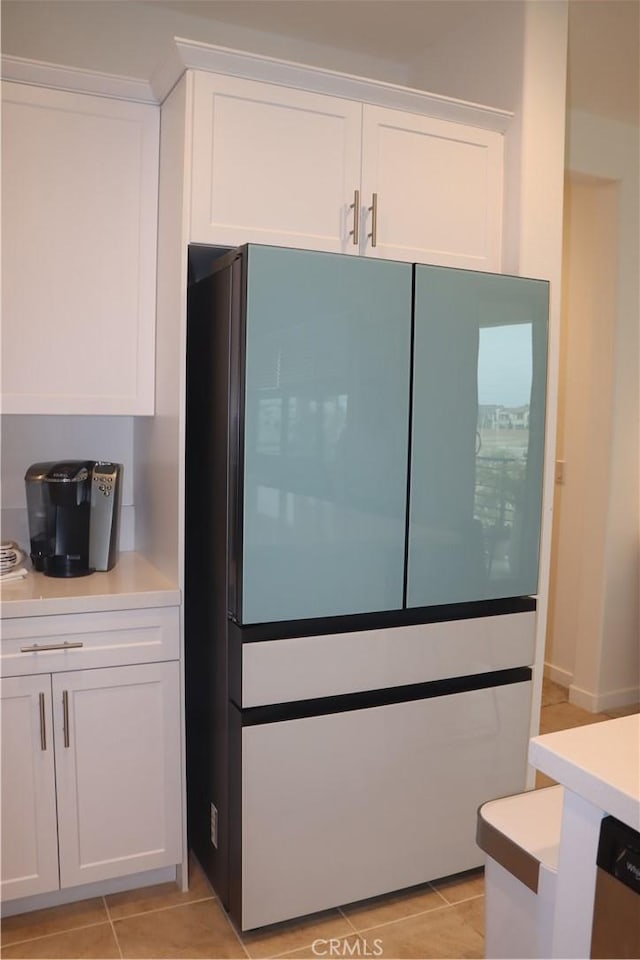 4211 E Malagon Privado Unit 66, Ontario, CA 91761 - kitchen with freestanding refrigerator, white cabinets, light tile patterned floors, and light countertops