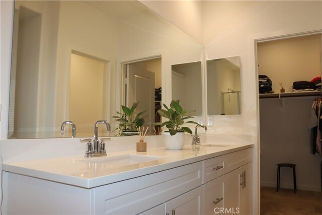 4211 E Malagon Privado Unit 66, Ontario, CA 91761 - full bathroom with double vanity, a sink, and a spacious closet