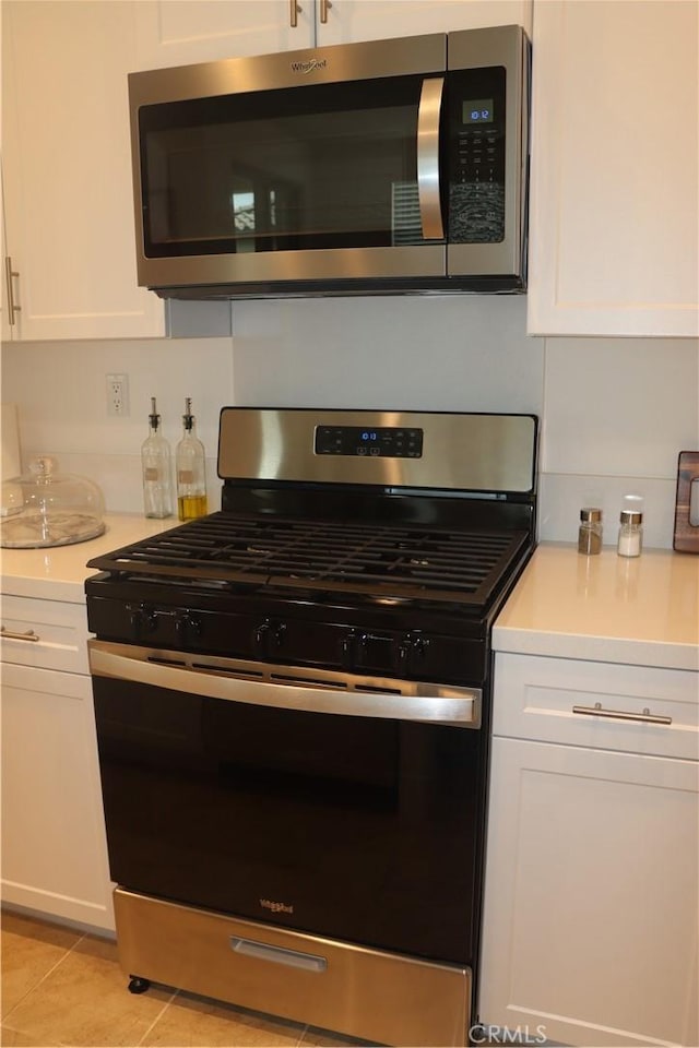 4211 E Malagon Privado Unit 66, Ontario, CA 91761 - kitchen featuring light countertops, white cabinets, and stainless steel appliances