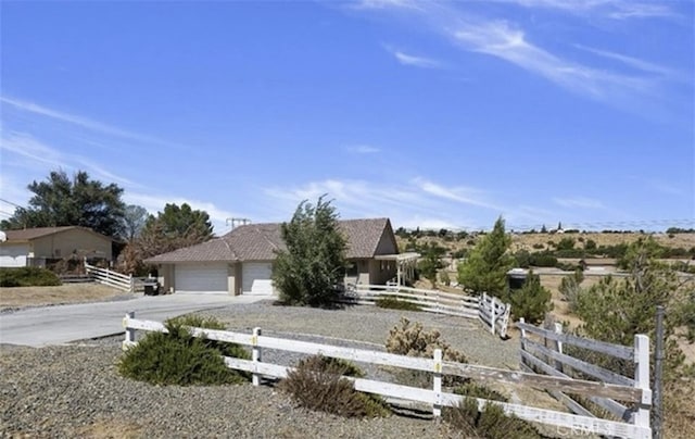 7548 Chase Ave, Hesperia, CA 92345 - view of property hidden behind natural elements featuring driveway, fence, and an attached garage