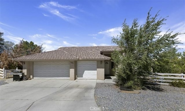 7548 Chase Ave, Hesperia, CA 92345 - view of front facade with stucco siding, fence, concrete driveway, and an attached garage