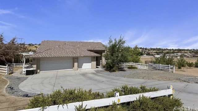 7548 Chase Ave, Hesperia, CA 92345 - view of front of property with fence, a garage, driveway, and stucco siding