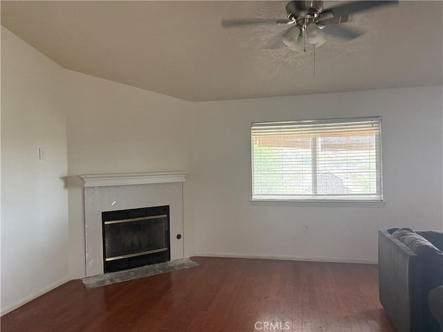 7548 Chase Ave, Hesperia, CA 92345 - living area with ceiling fan, wood finished floors, a tiled fireplace, and baseboards