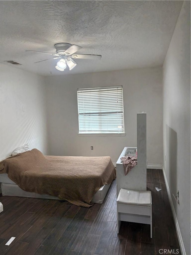 7548 Chase Ave, Hesperia, CA 92345 - bedroom featuring dark wood-style floors, a textured ceiling, baseboards, and ceiling fan