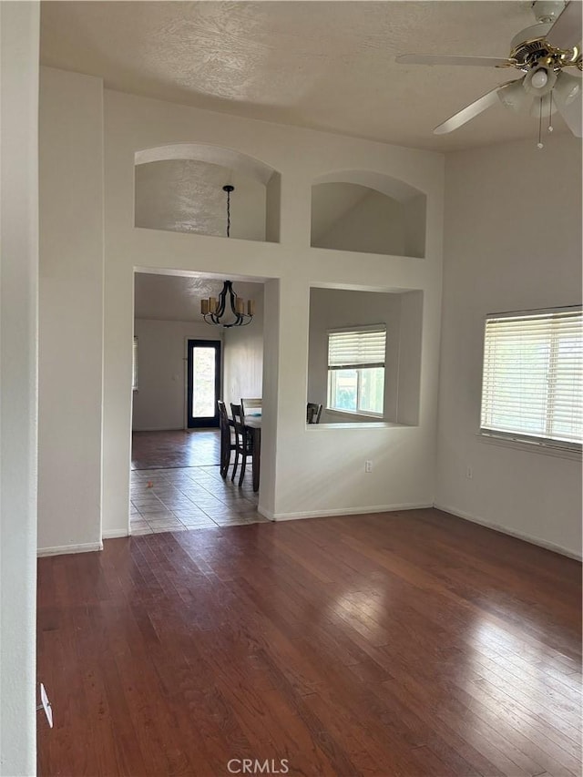 7548 Chase Ave, Hesperia, CA 92345 - empty room with plenty of natural light, wood finished floors, ceiling fan, and baseboards