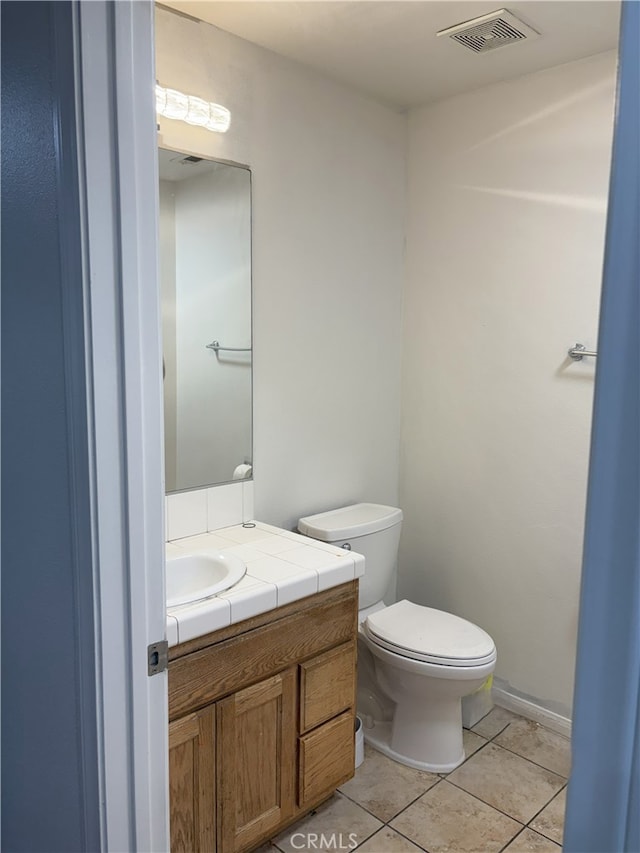 7548 Chase Ave, Hesperia, CA 92345 - half bath with tile patterned floors, toilet, and vanity