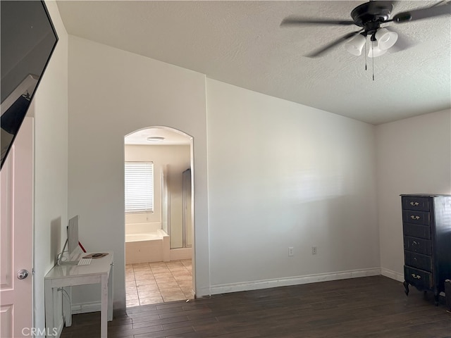 7548 Chase Ave, Hesperia, CA 92345 - unfurnished room featuring arched walkways, wood finished floors, ceiling fan, baseboards, and a textured ceiling