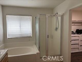 7548 Chase Ave, Hesperia, CA 92345 - bathroom featuring a stall shower, a garden tub, vanity, and a walk in closet
