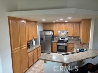 7548 Chase Ave, Hesperia, CA 92345 - kitchen with appliances with stainless steel finishes, ventilation hood, a peninsula, a sink, and a kitchen bar