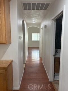 7548 Chase Ave, Hesperia, CA 92345 - hall featuring arched walkways, wood finished floors, and baseboards