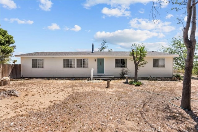 view of front of home featuring fence