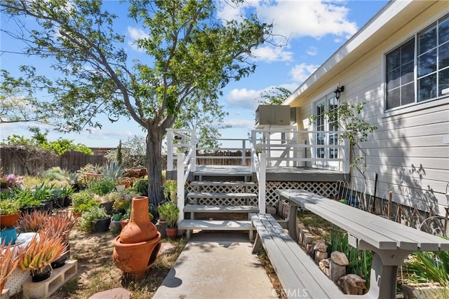 view of patio featuring fence and a deck