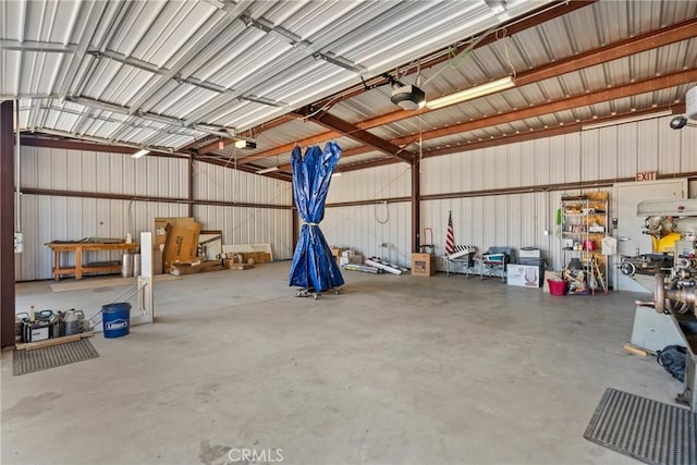 garage featuring a garage door opener and metal wall