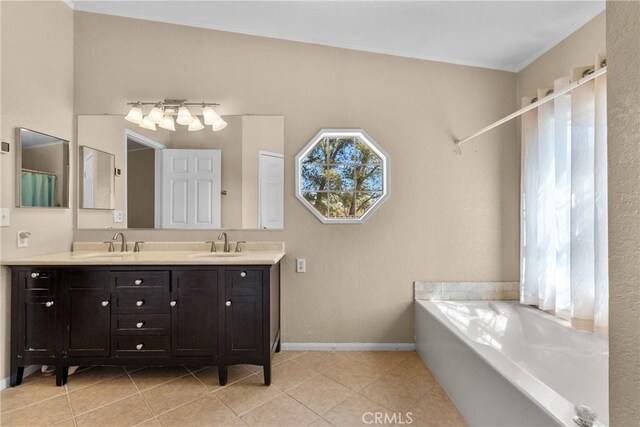 bathroom featuring double vanity, baseboards, a garden tub, and a sink