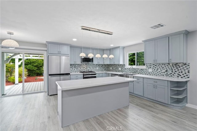 kitchen featuring light wood finished floors, visible vents, gray cabinets, and appliances with stainless steel finishes