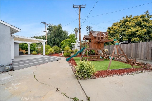 view of playground with a yard, a patio area, and fence