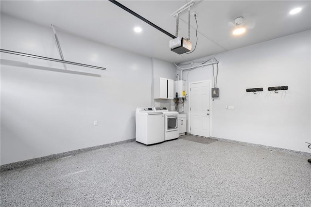 garage featuring washing machine and clothes dryer, baseboards, a garage door opener, and water heater