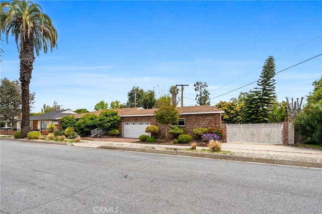 ranch-style home with fence and a garage