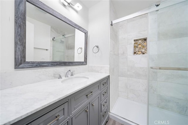 full bath featuring a stall shower and vanity