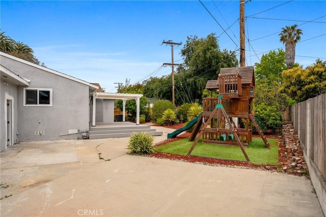 view of play area featuring a yard, a patio area, a pergola, and fence private yard