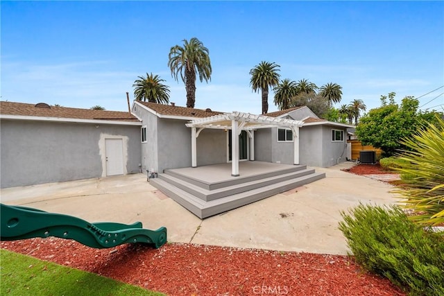 rear view of house featuring a patio, stucco siding, a pergola, a deck, and central air condition unit