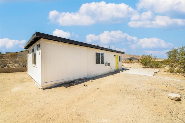view of side of property with a patio area