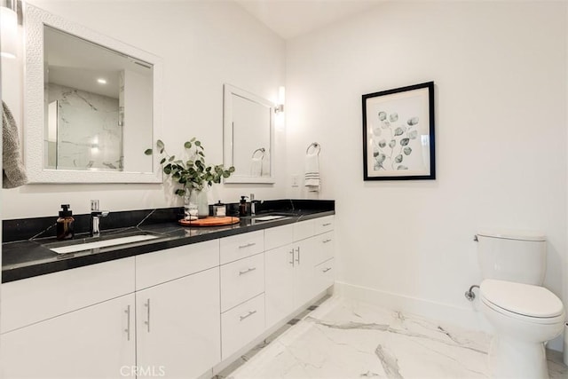 4322 Gentry Ave Unit 104, Studio City, CA 91604 - full bathroom featuring a sink, double vanity, toilet, marble finish floor, and baseboards