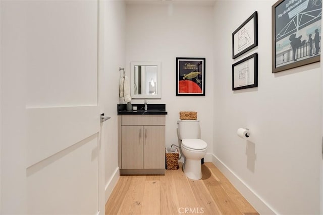 4322 Gentry Ave Unit 104, Studio City, CA 91604 - bathroom with toilet, baseboards, wood finished floors, and vanity