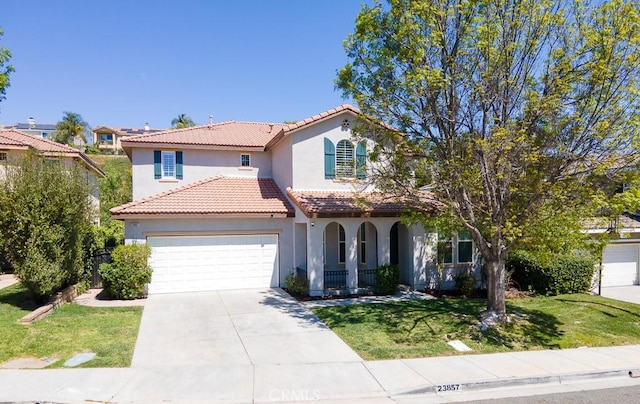 mediterranean / spanish house with a front lawn, covered porch, stucco siding, an attached garage, and a tile roof