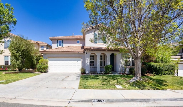 view of front facade with a garage, stucco siding, a tile roof, and a front yard