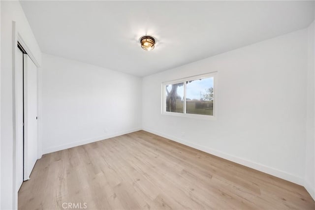 4832 Olive St, Montclair, CA 91763 - unfurnished bedroom with a closet, baseboards, and light wood-type flooring