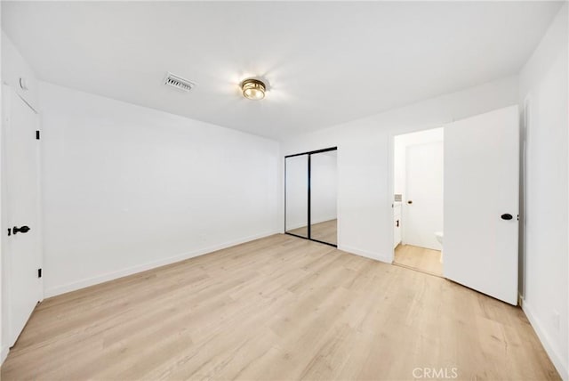 4832 Olive St, Montclair, CA 91763 - unfurnished bedroom with baseboards, a closet, light wood-type flooring, and visible vents