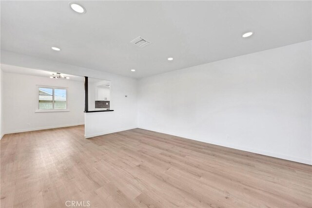 4832 Olive St, Montclair, CA 91763 - unfurnished living room with baseboards, light wood-type flooring, recessed lighting, and visible vents