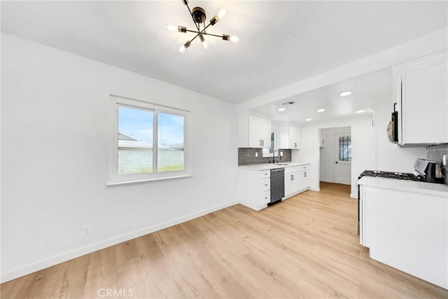 4832 Olive St, Montclair, CA 91763 - kitchen featuring an inviting chandelier, decorative backsplash, baseboards, dishwashing machine, and light wood-style flooring