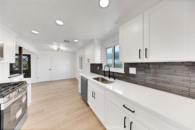 4832 Olive St, Montclair, CA 91763 - kitchen featuring decorative backsplash, recessed lighting, light countertops, a sink, and appliances with stainless steel finishes