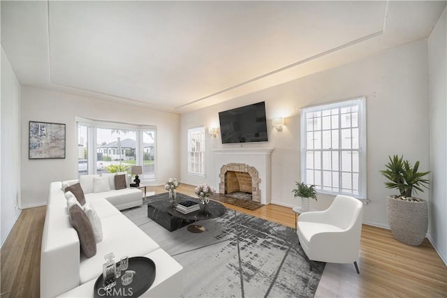 3712 Virginia Rd, Los Angeles, CA 90016 - living area featuring a fireplace with flush hearth, baseboards, and wood finished floors